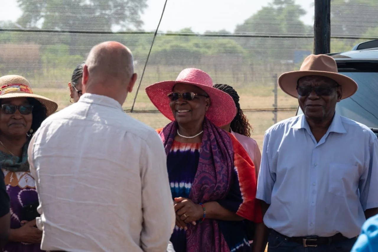 Visitors in conversation with the team during a farm visit